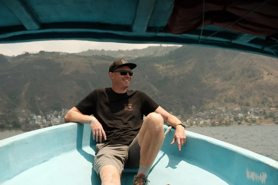 Derek Miller on a boat in Guatemala